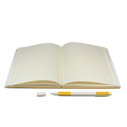 Open notebook with ruled pages and yellow gel pen.