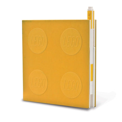 Yellow locking LEGO notebook with gel pen, embossed stud pattern on cover.