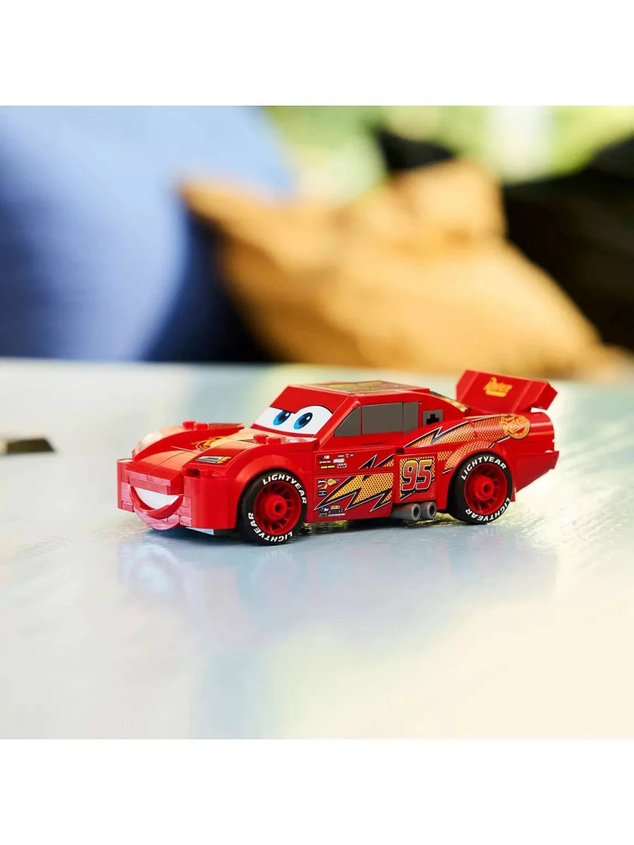 Red Lightning McQueen car model with #95 and blue eyes, angled side shot