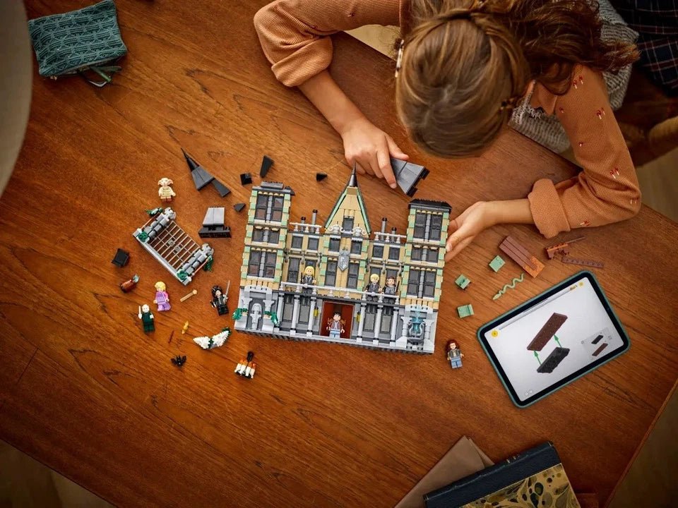 Malfoy Manor LEGO castle build on table with minifigures and loose accessory pieces