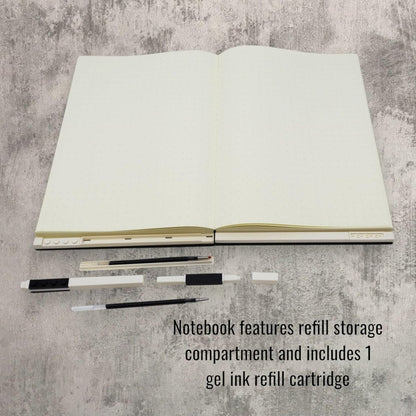 Open notebook with black gel pen refills and refill storage pieces