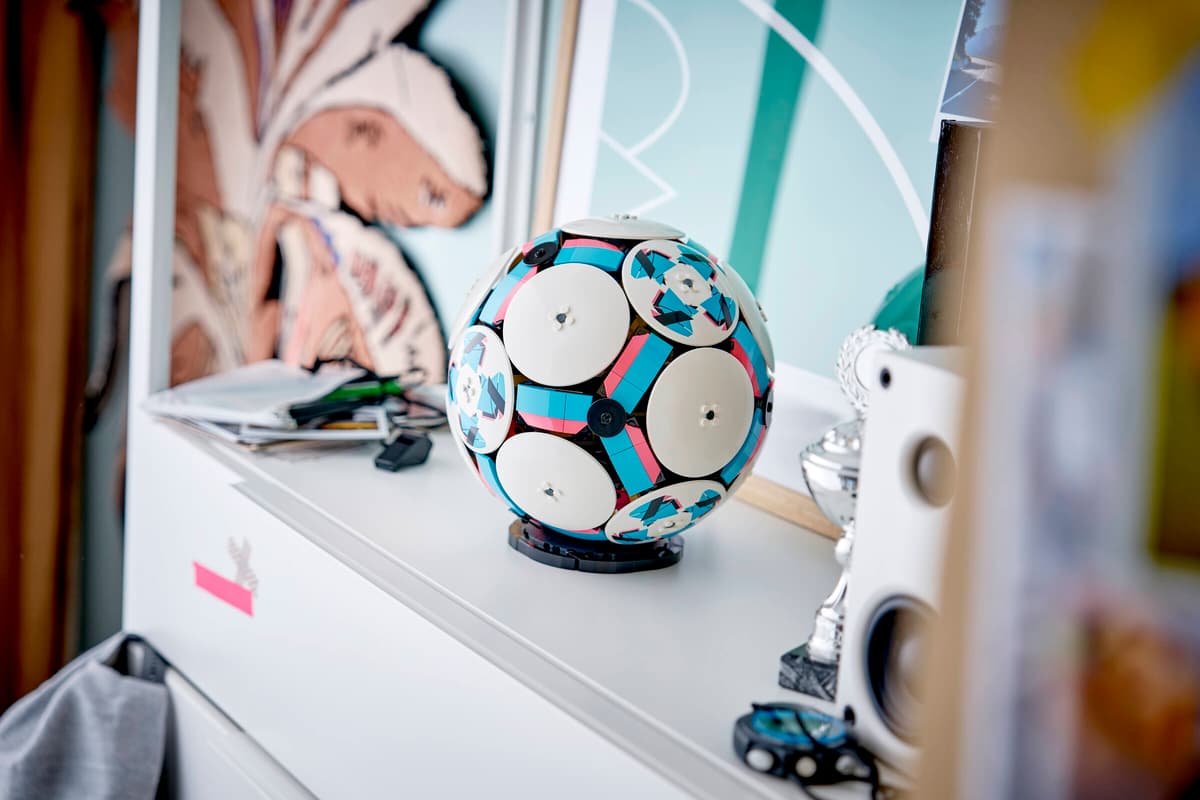LEGO rotating soccer ball toy on display with white discs and colorful interior