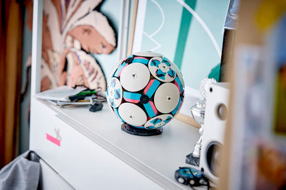 LEGO rotating soccer ball toy on display with white discs and colorful interior
