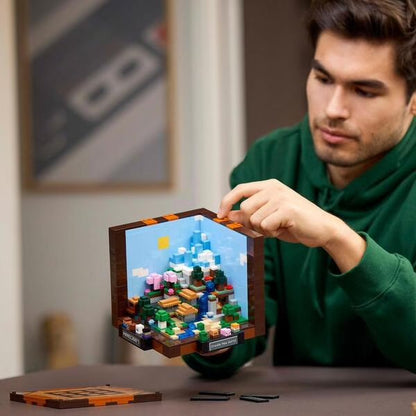 LEGO Minecraft crafting table build held by person, with colorful blocks visible