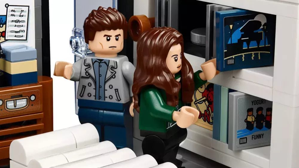 Mini figures seated in The Cullen House living area with couch and wall cabinet details