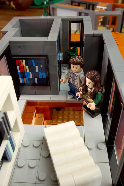 Mini figures on narrow upper walkway beside stairs inside The Cullen House model