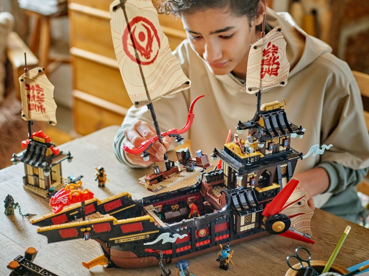 The Temple Bounty set as a child builds the ninja ship on a table