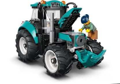 Teal and black LEGO tractor building set, front 3/4 view with driver figure