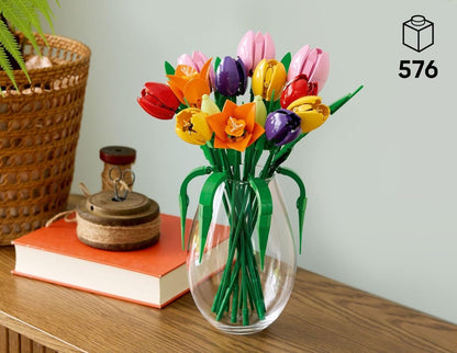 Tulip Bouquet in clear vase with green stems and purple, red, yellow, pink tulip heads