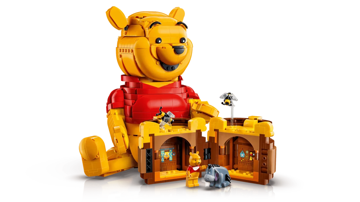 LEGO Winnie the Pooh with honey house and small figures beside the honey pot