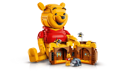 LEGO Winnie the Pooh with honey house and small figures beside the honey pot