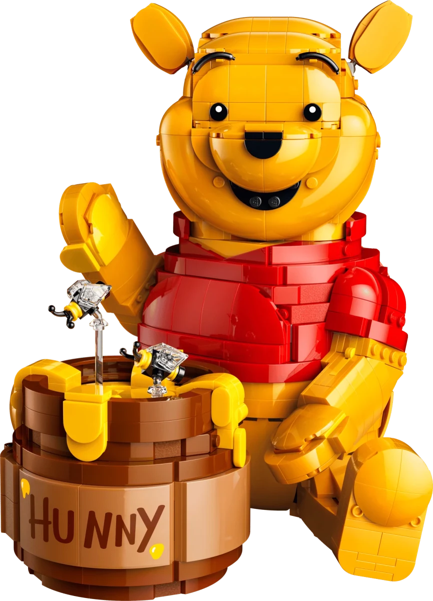 LEGO Winnie the Pooh figure close-up holding a brown honey pot with honey dipper