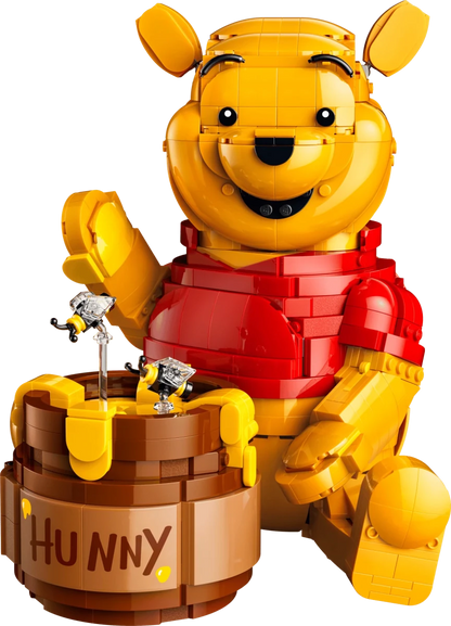 LEGO Winnie the Pooh figure close-up holding a brown honey pot with honey dipper