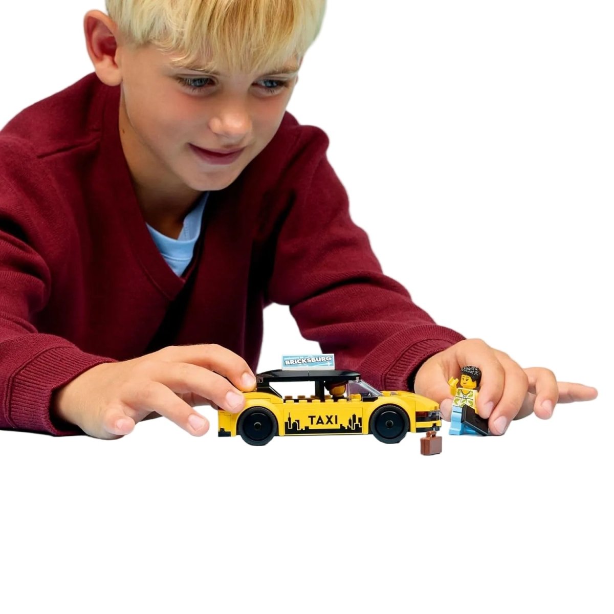 Yellow Taxi car build: yellow taxi with TAXI print, held by child with minifigure