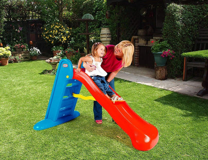 Kids plastic slide with blue ladder and orange chute, child about to ride