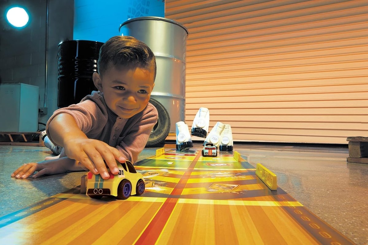 Toy car race track playset with a yellow car and small vehicles on lanes