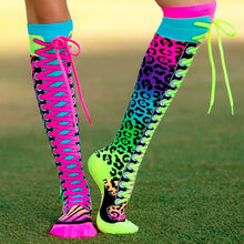 Knee-high neon socks with leopard print sides and bright top cuffs, worn