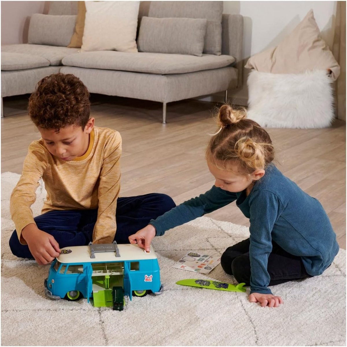 Volkswagen T1 transporter toy van on rug, being played with by children