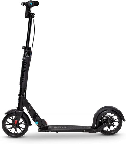 Black kick scooter with headlight on handlebar, wide standing deck, and pneumatic tires
