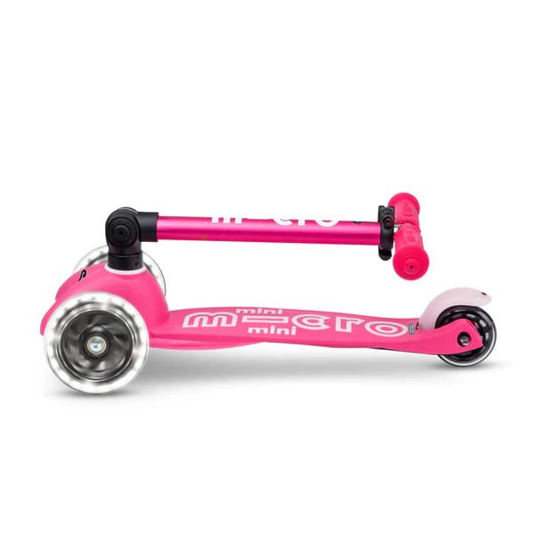 Pink foldable mini LED scooter, side view with large front and rear wheels