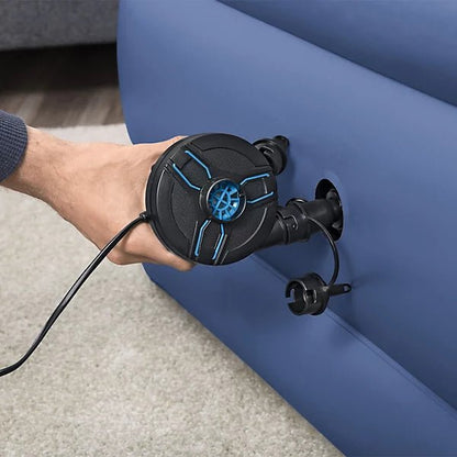 Hand using AC/DC air pump nozzle on inflatable mattress, black pump with blue details