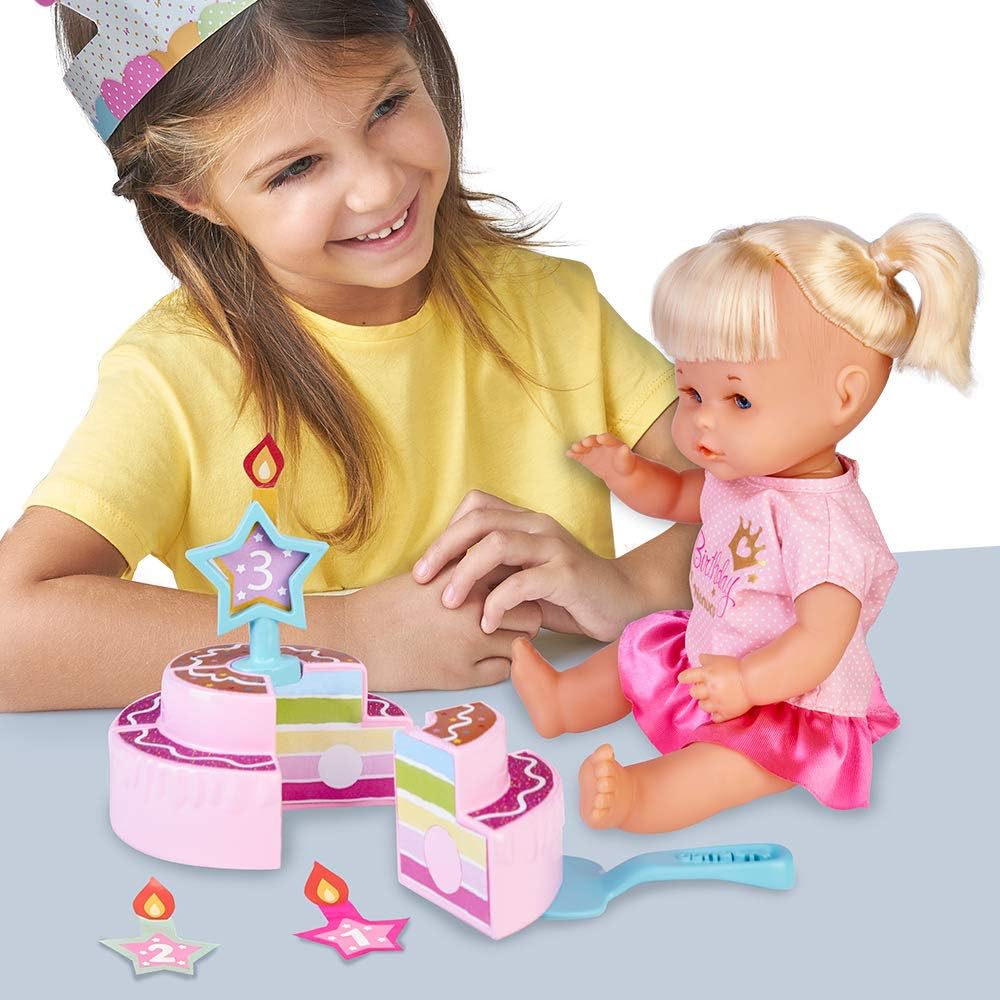 Baby doll in pink birthday outfit with blonde pigtails next to child and toy cake