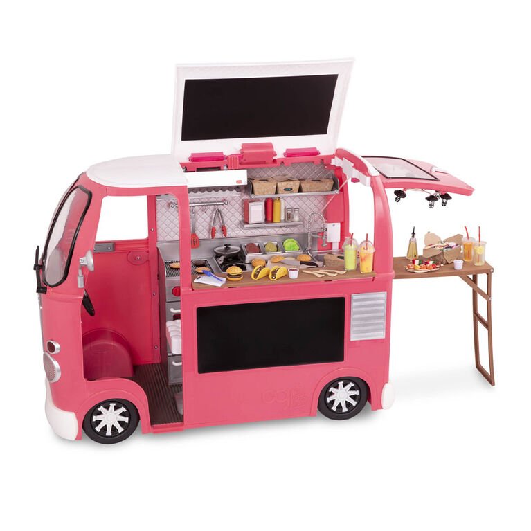 Pink toy food truck playset with open kitchen bay, side table, and assorted food pieces