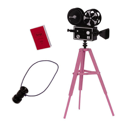 Toy movie camera on pink tripod with black reel, script card, and remote-style cable.
