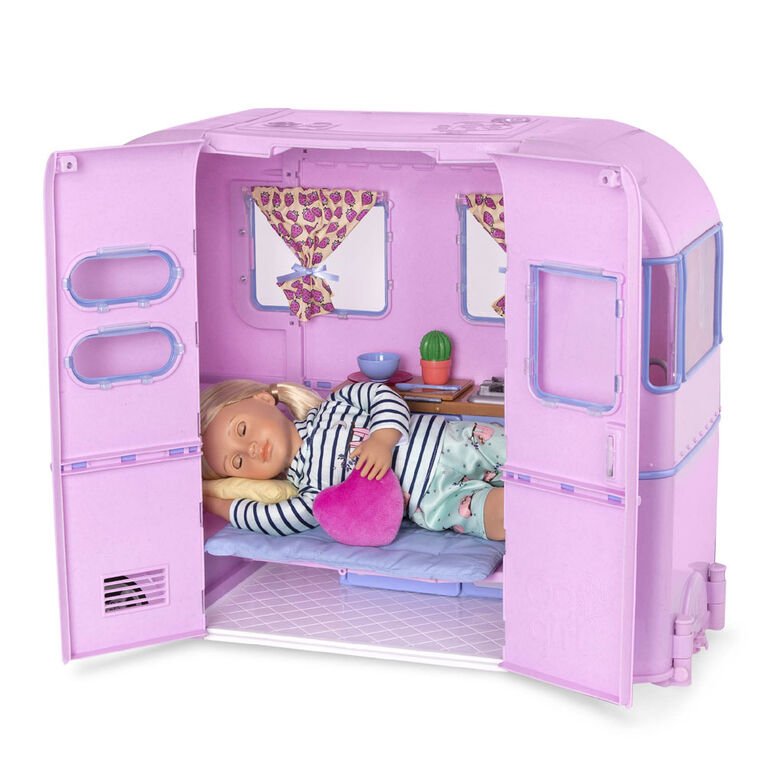 Playset camper trailer with sleeping area, doll on mattress, and heart pillow