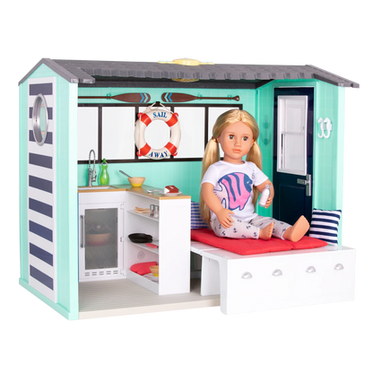 Seaside Beach House playset with doll on sofa bed and kitchen appliances