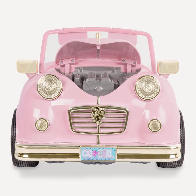Pink retro convertible toy car front with open hood, headlights, chrome grille, and license plate.