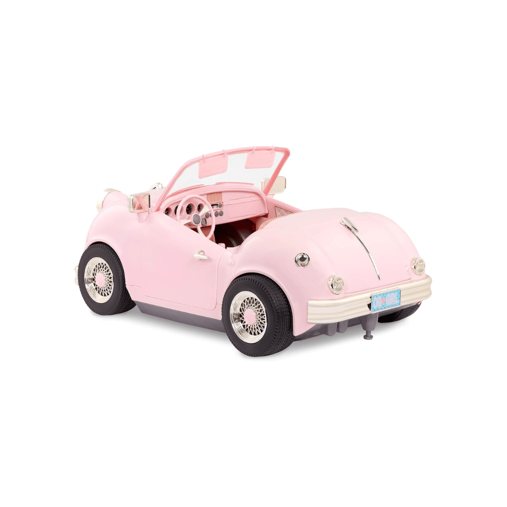Pink retro convertible toy car, side view, open top and chrome bumper detail.