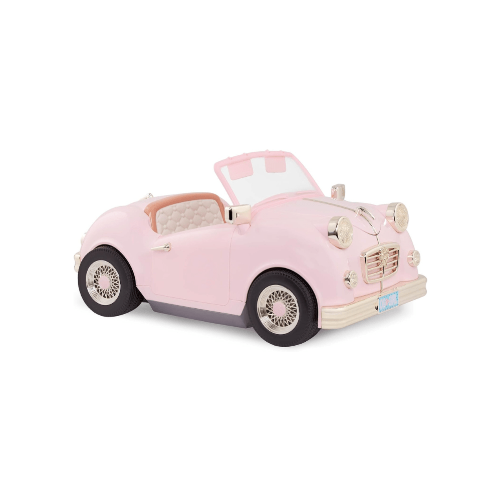 Pink retro convertible toy car with open top, chrome grille, and whitewall wheels.