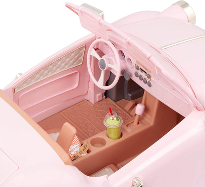 Pink convertible toy car interior with steering wheel, dashboard buttons, and seats.