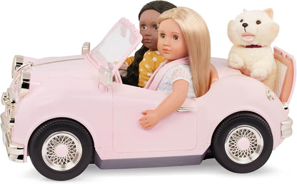 Pink convertible toy car with two seated dolls and cream interior, open top.