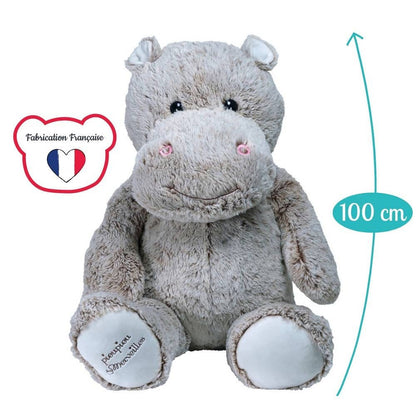 Giant gray plush hippo with pink blush accents, seated with arms at sides
