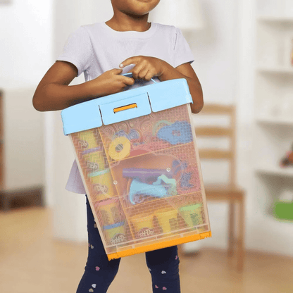 Transparent accessory box with orange lid, held by a child