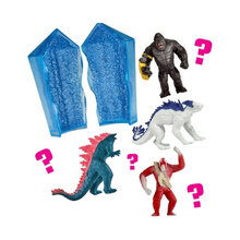 Clear blue crystal capsules and multiple Godzilla x Kong figures, with pink question marks