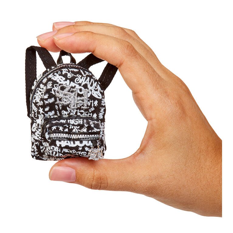 Mini printed backpack-style bag with black straps and white text pattern