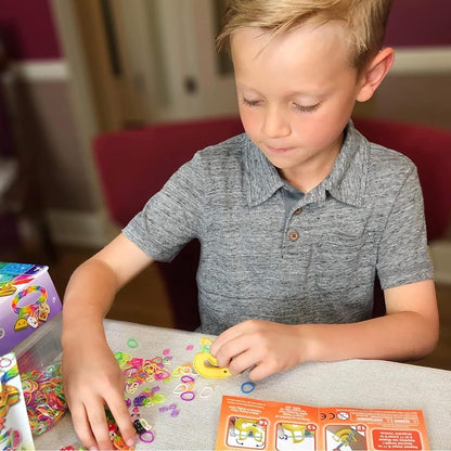 Child’s hands arranging colorful Rainbow Loom pieces on a beading mat