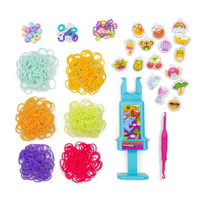 Rainbow rubber band bracelet kit pieces, including multiple band reels and charm accessories