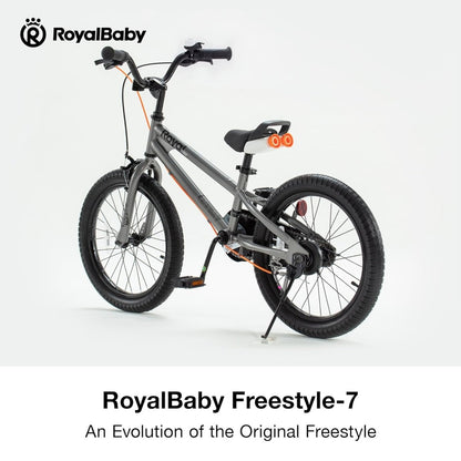 Grey kids bike with black handlebar, orange frame stripe, and front wheel on stand