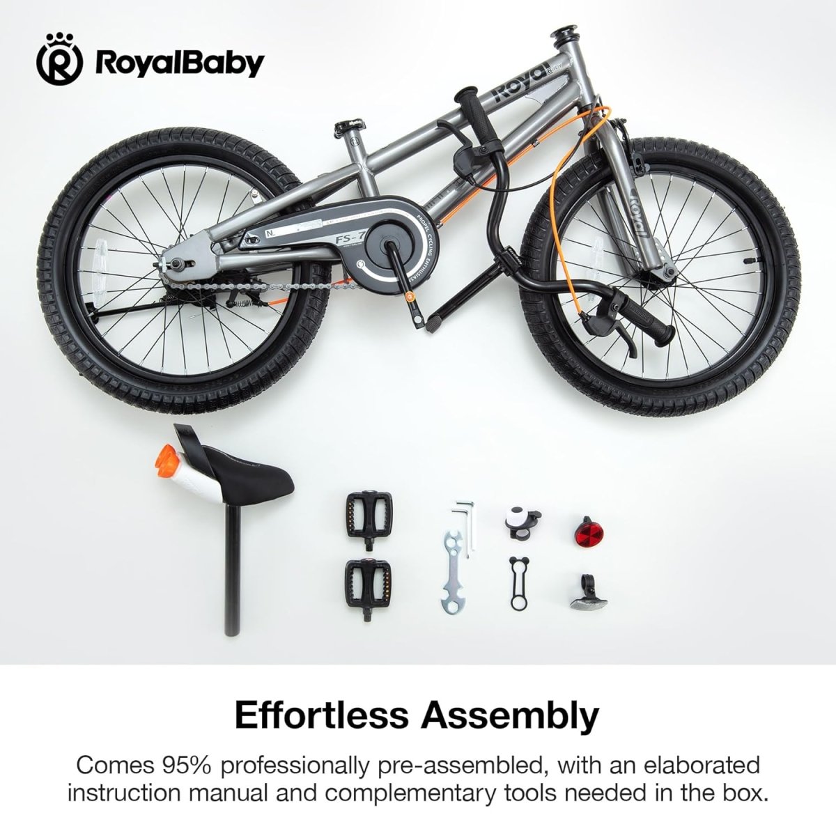 Grey kids bike with included assembly tools and parts, including pedals and wrench