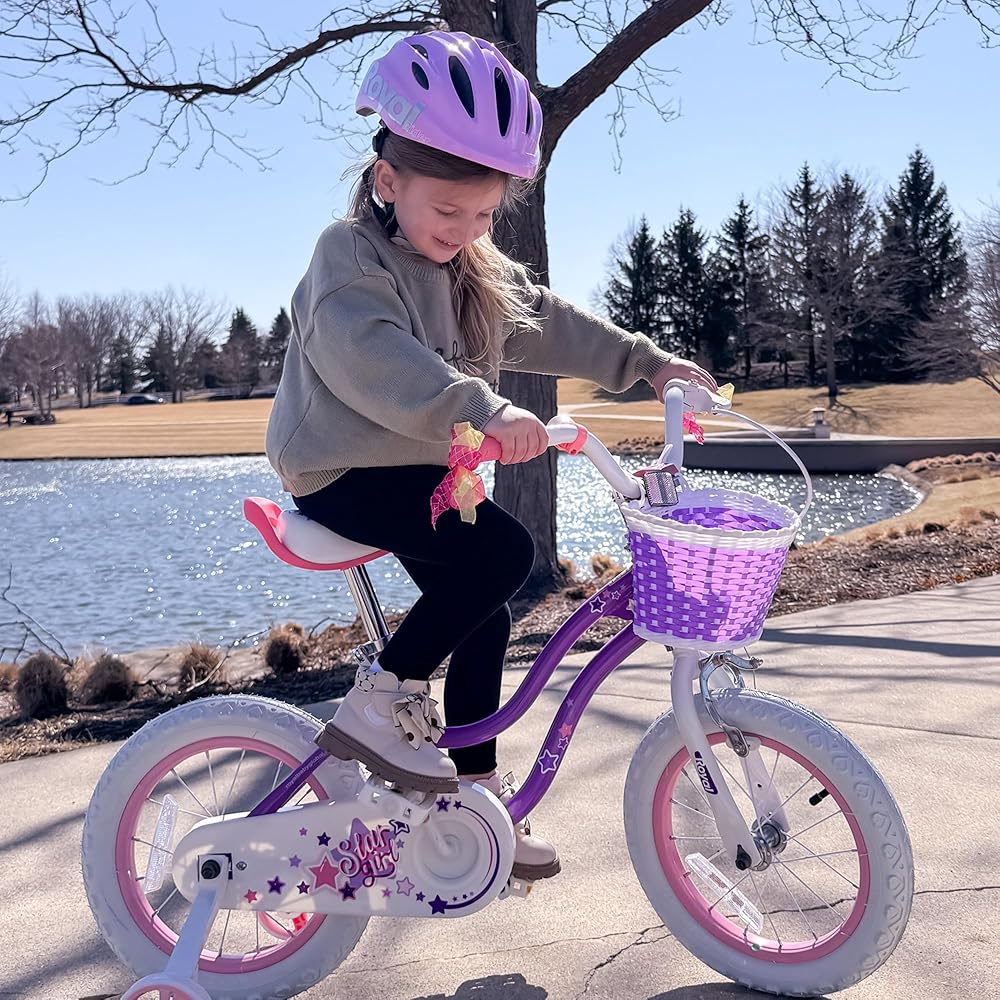 Kids purple bicycle with front purple basket, pink bell, and star decals on white fenders
