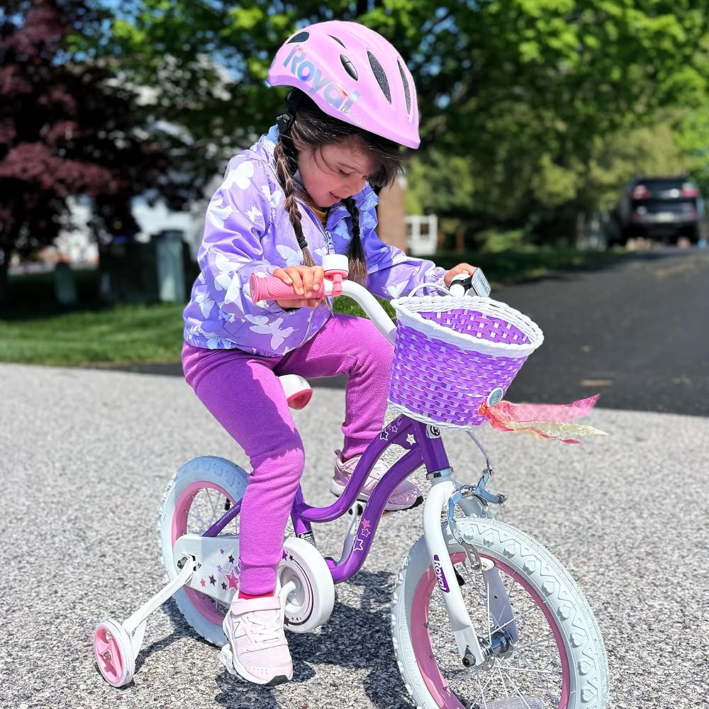 Kids purple bicycle with front basket and star decals, pink wheels, and white frame