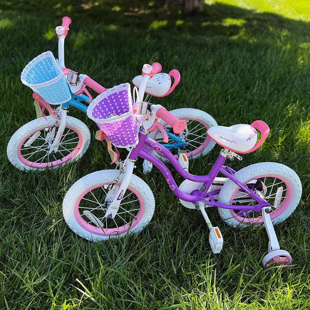 Kids purple bicycle with rear pink training wheels, front basket, and white star decals
