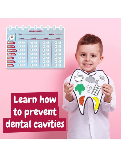 Child holding dental chart and tooth illustrations in dentist-themed learning kit