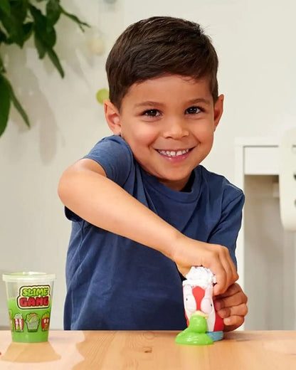 Child squeezing white slime from green character slime heads squeeze figure