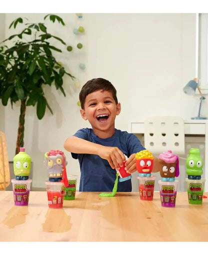 Slime heads squeeze toy figures with character faces on table in front of child