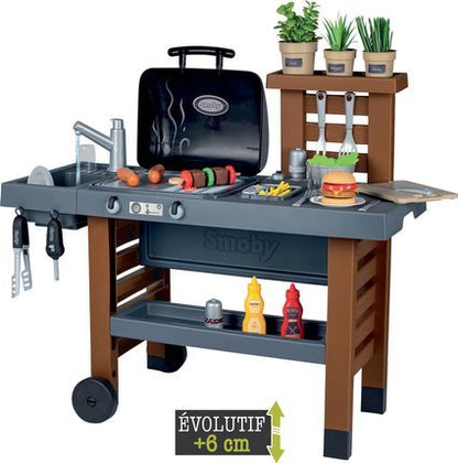 Smoby garden kitchen play set with black grill hood, gray counter burners, and shelves
